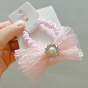 Pink mesh bow scrunchie with faux pearls and rhinestone trim on display card
