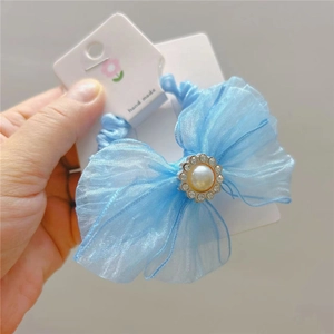 Close-up of light blue organza bow hair tie with pearl and rhinestone flower detail