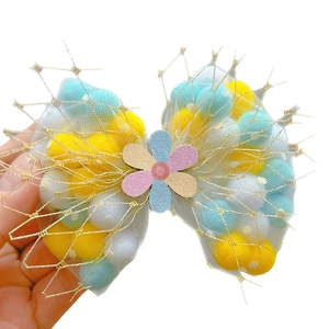 Cute girls hair clip with mesh bow filled with colorful pom poms and glitter flower charm