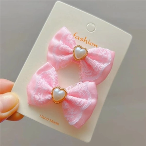 Noeuds à cheveux en satin rose avec dentelle blanche et perle de cœur sur carte