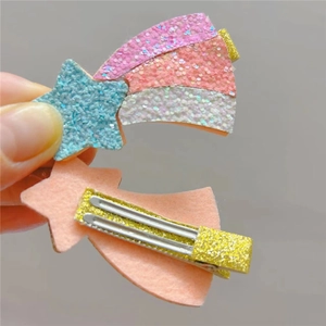 Detail of glitter star and rainbow hair clip with gold sequined alligator hairpins