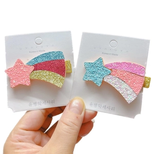 Glittery star and rainbow shooting star hair clips for kids on a display card