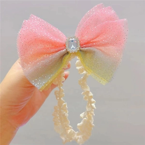 Infant lace headband with gradient pink and yellow mesh bow and sparkling rhinestone gem