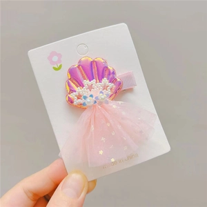 Iridescent shell hair clip for girls with pink tulle skirt and star sequins on card