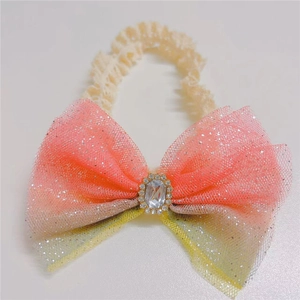 Detail of baby headband with gradient tulle bow and sparkling gemstone centerpiece