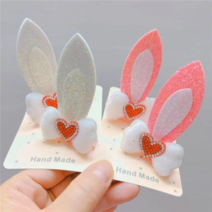 Detail of plush rabbit ear hair clips with sequins and sparkling rhinestone heart accents
