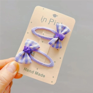 Pair of purple plaid fabric bow hair clips for kids handmade with a sweet classic pattern