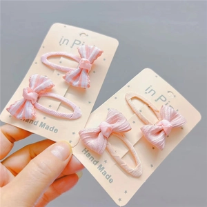 Detail of handmade pink fabric plaid bow hair clips for girls on display card