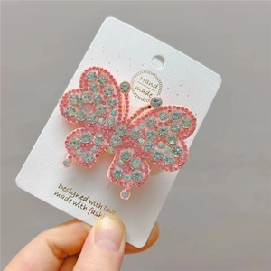 Elegant large butterfly hair clip with pink edges and sparkling crystals on card