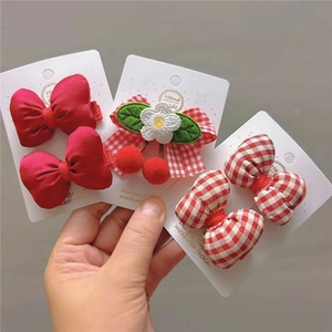 Detailed set of handmade Lolita hair clips with red bows, gingham patterns and pom-poms