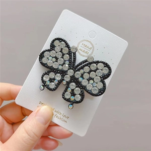 Elegant butterfly hair clip with sparkling rhinestones on a black alloy base for women