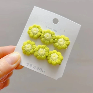 Handmade crochet flower hair clips in yellow and beige for girls on display card