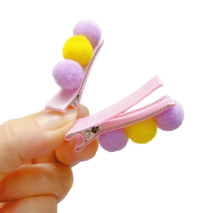 Cute girls hair clips with colorful plush pom poms on pink ribbon wrapped alligator clips