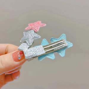 Detail showing pink and silver glitter stars with blue fabric star on a metal hair clip