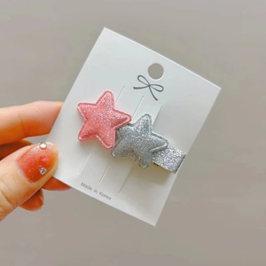 Sweet star-shaped glitter hair clips in pink and silver on a white display card