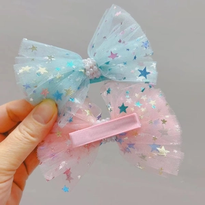Détail de barrettes à nœuds en tulle avec paillettes étoiles et perles pour filles