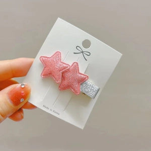Pink glitter star hair clips set on white card display with sparkling silver accents