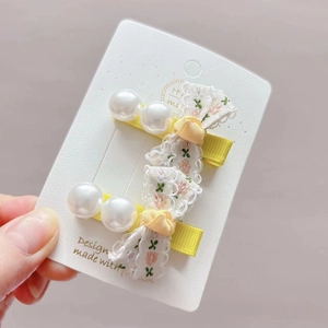 Pair of yellow lace bow hair clips for girls with carrot embroidery and white pearls