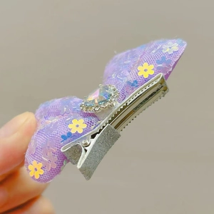 Detail of lilac tulle bow hair clip with heart gem, sequins and silver metal clip