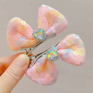 Pink sequin bow hair clips for kids with heart gems and rhinestones on silver duckbill clips