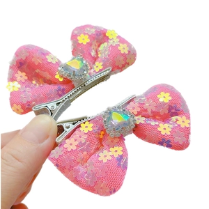 Pink sequin bow hair clips for girls with heart-shaped gemstone and glitter accents