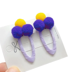Kids hair clip set with colorful pom-poms on purple ribbon wrapped metal clips