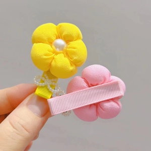 Detail of fabric flower hair clips with pearls and ribbon wrapped clips for kids