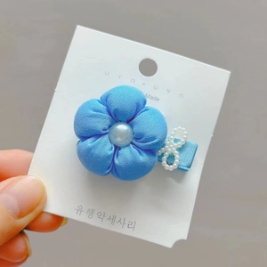 Sky blue fabric flower hair clip with pearl bow on display card for toddlers