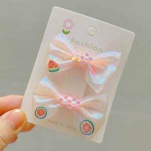 Détail de barrettes à cheveux à nœuds colorés pour filles avec fleurs en perles