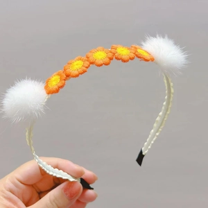 Cute crochet flower headband with mink fur balls and orange daisy design for girls