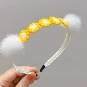 Cute floral headband with yellow daisy embroidery and white faux fur mink pom poms