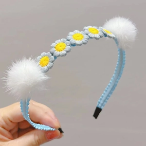 Cute light blue headband with embroidered daisies and fluffy white mink fur balls