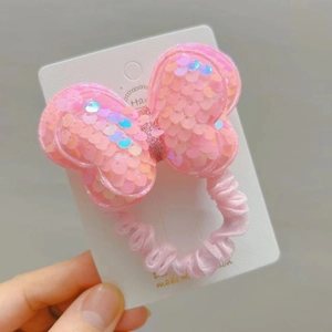 Pink sequin bow hair tie for girls featuring a sparkly fabric elastic scrunchie design
