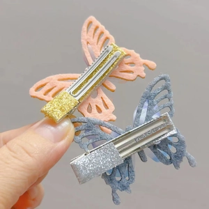 Detail view of felt butterfly hair clips with glitter accents for girls and toddlers