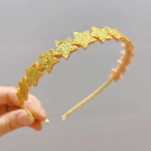 Close-up of sparkling gold sequin stars on a princess headband for girls and children