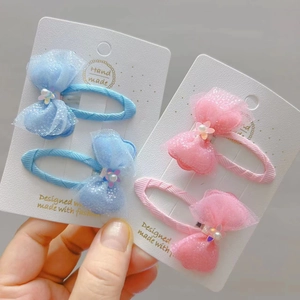 Detail of handmade lace bow hair clips with pearls and sequins for young girls