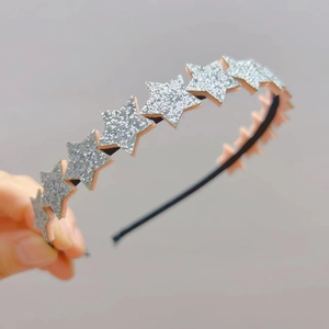 Close-up of sparkling silver glitter star headband for girls with detailed texture