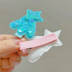 Detail of star hair clip featuring colorful sequins and a felt-backed metal duckbill clip