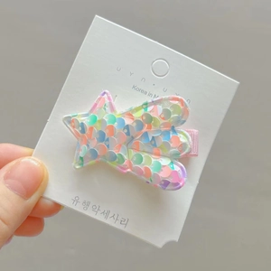 Detail showing the colorful sequin star hair clip with pink fabric covered metal alligator clip
