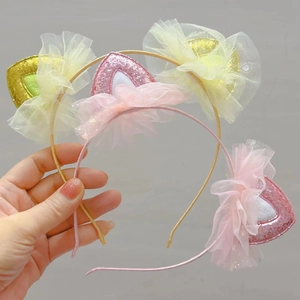 Detail of pink glittery cat ear headband with soft mesh trim for kids parties
