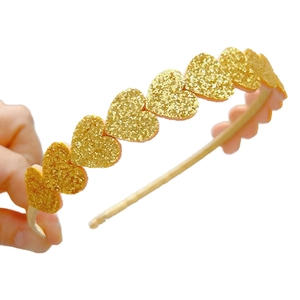 Sparkling gold glitter heart headband for girls party hair accessory shown in hand