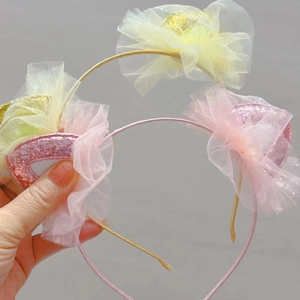 Detail of pink and gold glitter cat ear headbands with lace and mesh for kids
