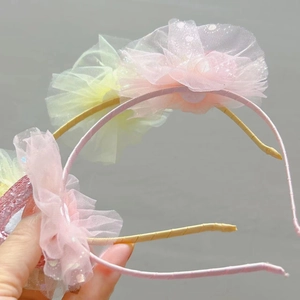 Detailed macro view of pink tulle flower petals with glitter accents on cat ear headband