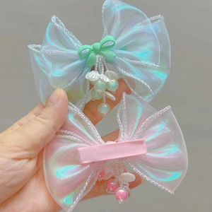 Detail of iridescent organza bow hair clip with beaded pendants and safety alligator clip