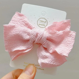 Elegant triple-layered pink bow hair clip with textured crepe fabric for girls