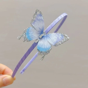 Detail of purple satin headband with a glittery blue-violet gradient butterfly and rhinestones