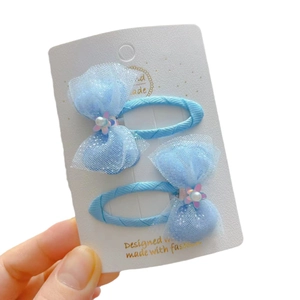 Set of two light blue lace bow hair clips with pearls and sequins for children