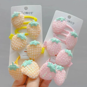 Detail of sequin strawberry and pineapple hair clips set for girls on display card