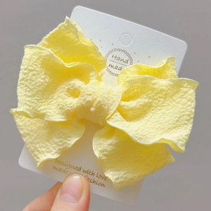 Elegant yellow seersucker fabric triple layer bow hair clip on decorative display card