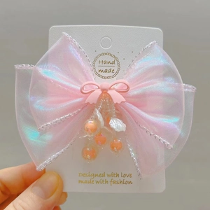 Pink handmade mermaid bow hair clip with iridescent mesh and beaded shell charms